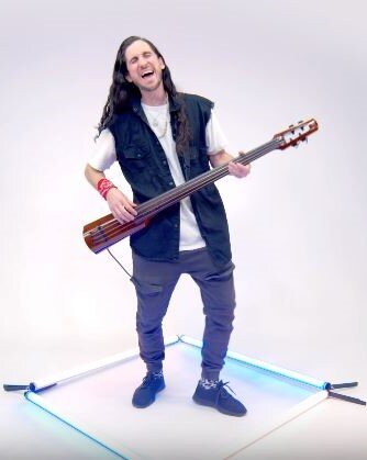 Photograph of NS Design Artist Gianni Illuminati playing his WAV4 Omni Bass with Walk Off The Earth.
