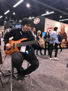 NS Artist Killian Duarte with the prototype NS CR6 Bass Guitar at the Winter NAMM 2020 NS Design Booth