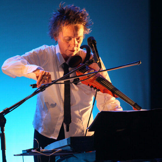 Photograph of NS Design Artist Laurie Anderson playing the CR5 Electric Violin.
