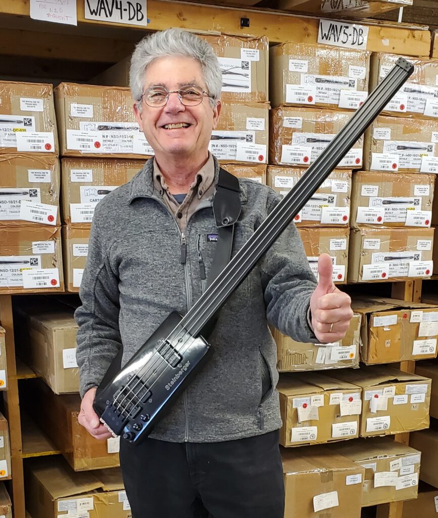 Ned Steinberger circa 2025 with the first Steinberger bass sold: a fretless L2 that Tony Levin bought. Levin used this bass on John Lennon’s Double Fantasy sessions.